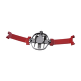 A red and silver coil spring trap setter with metal levers and a rubber handle.